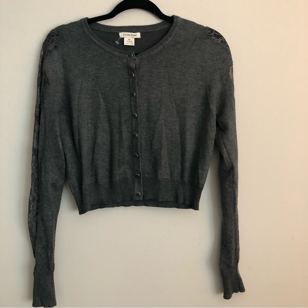 Dark Grey cardigan with lace detailing down the sleeves. Size medium- like new.